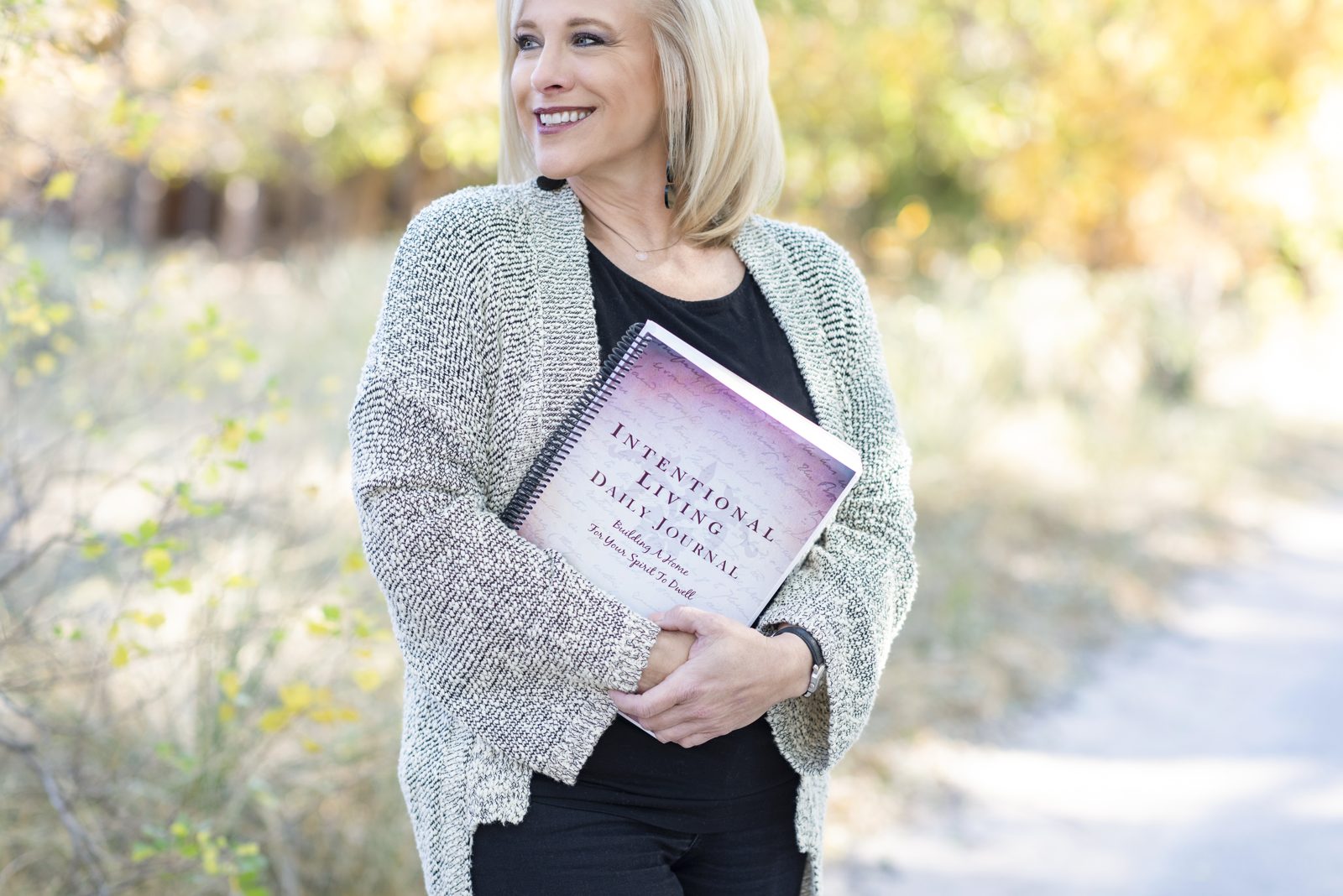 Linda holding the Intentional Living Daily Journal